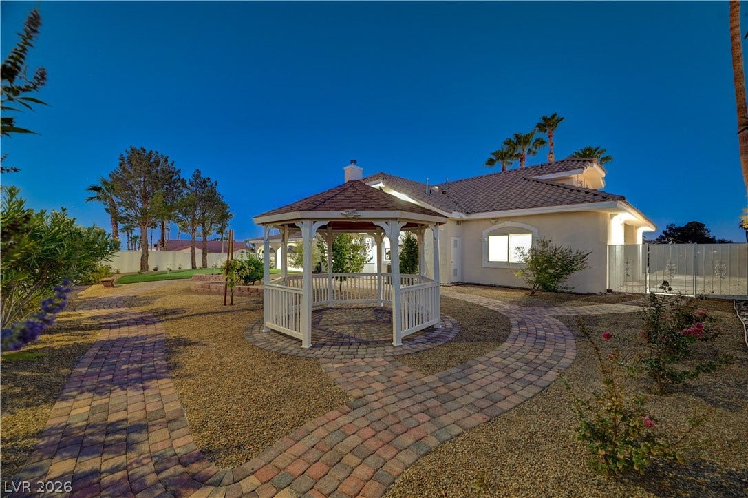 2000 Alexa Breanne Court, Las Vegas, NV 89117 Inviting brick paver pathways wind through a landscaped yard featuring a central gazebo structure.