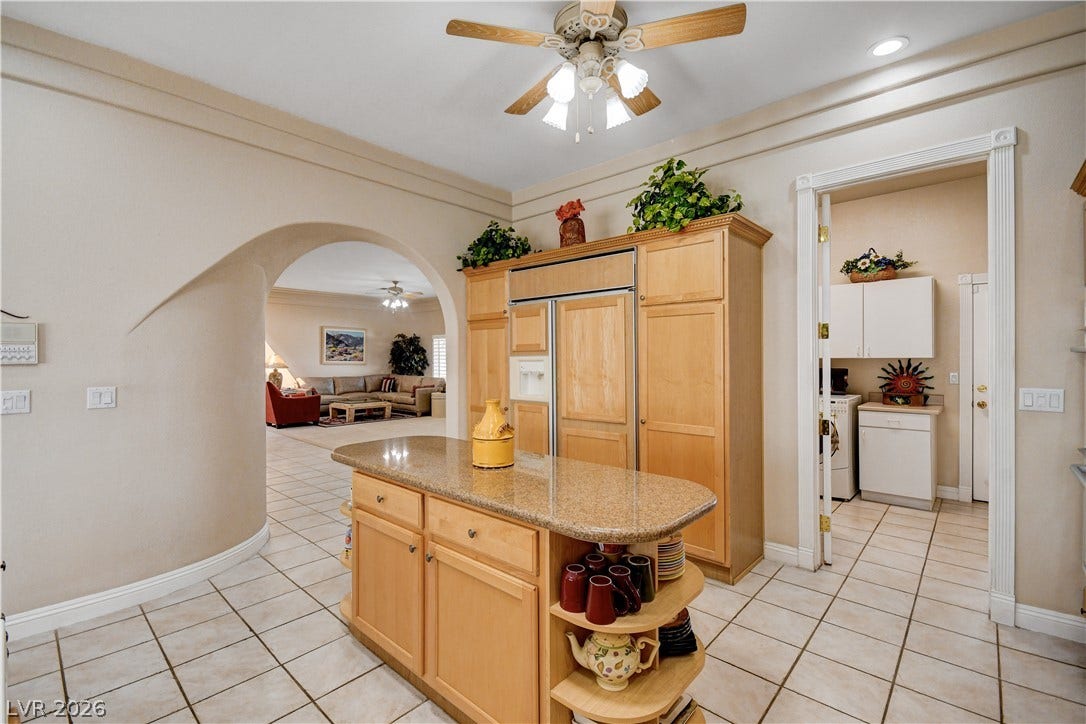 2000 Alexa Breanne Court, Las Vegas, NV 89117 An arched doorway opens to the living areas from this kitchen featuring a central island.