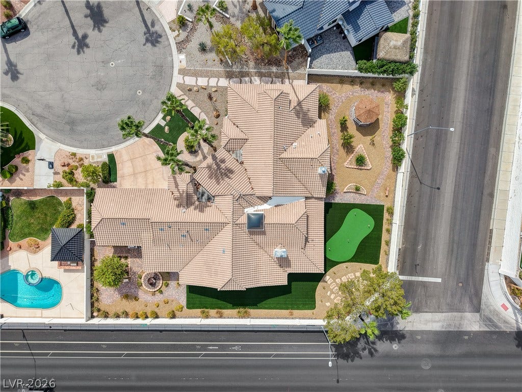 2000 Alexa Breanne Court, Las Vegas, NV 89117 An aerial perspective showcases a tiled roof structure nestled within beautifully landscaped desert grounds.