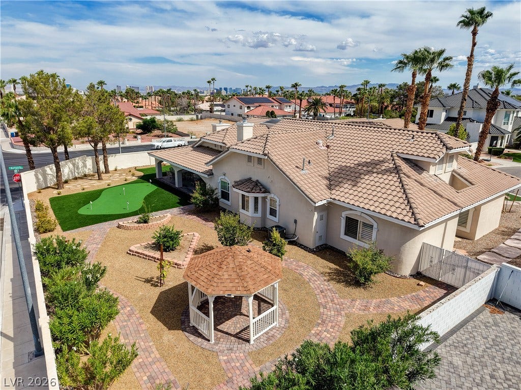 2000 Alexa Breanne Court, Las Vegas, NV 89117 An expansive tiled roof caps this elegant residence nestled alongside a private backyard putting green.