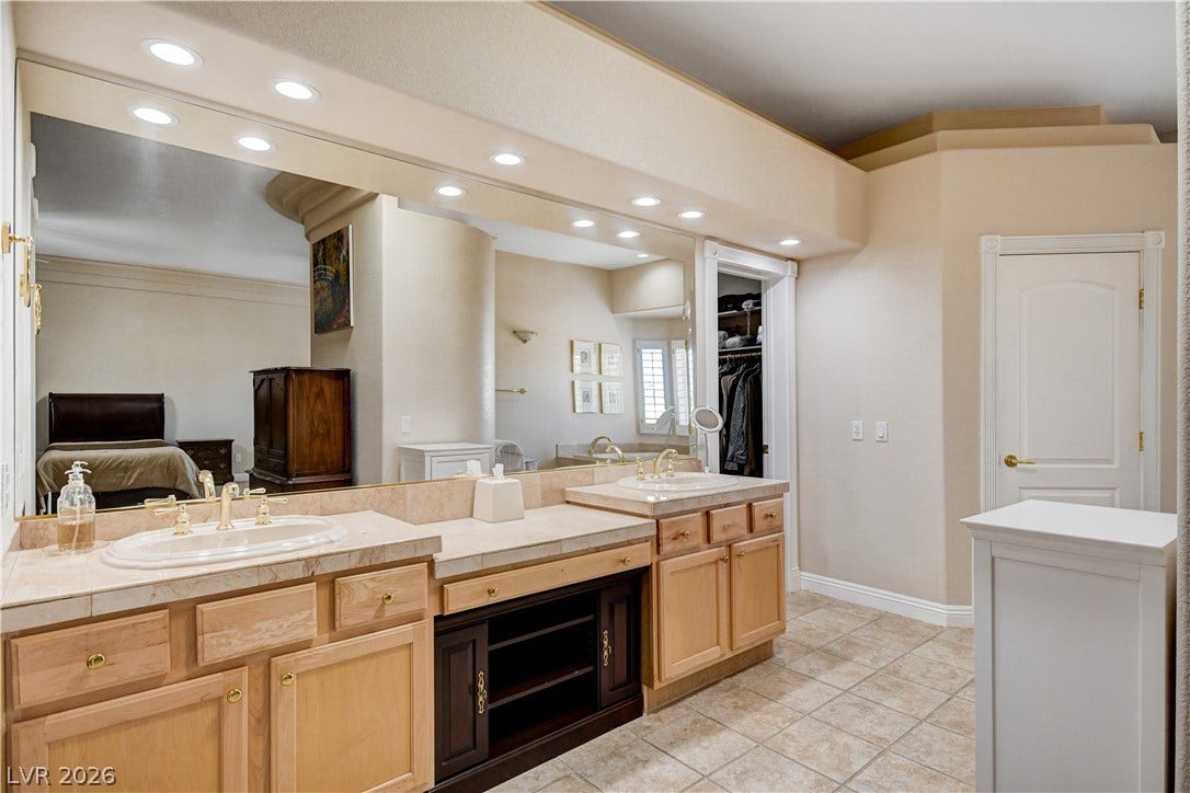 2000 Alexa Breanne Court, Las Vegas, NV 89117 Ample counter space and built-in lighting define this functional double vanity bathroom.