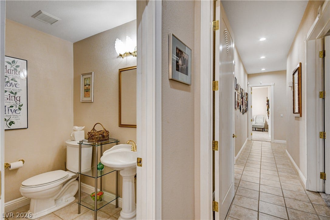 2000 Alexa Breanne Court, Las Vegas, NV 89117 Tiled flooring extends through the hallway adjacent to a convenient powder room.