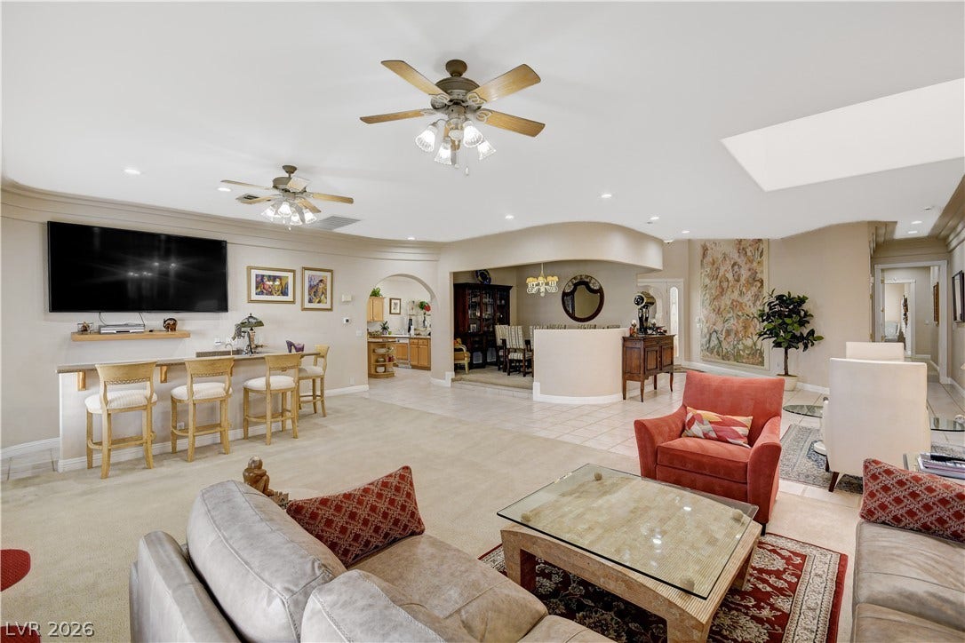 2000 Alexa Breanne Court, Las Vegas, NV 89117 Crown molding and an open-concept layout define this sprawling, carpeted living space.