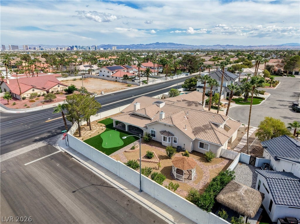 2000 Alexa Breanne Court, Las Vegas, NV 89117 An aerial perspective showcases the tiled roofline and structured backyard featuring a private putting green.