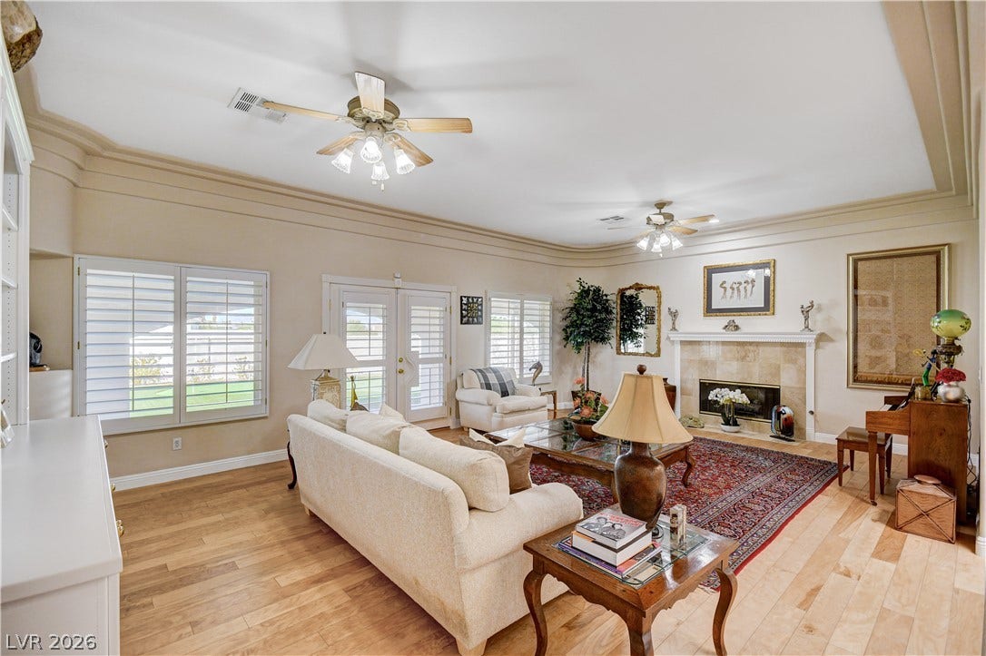 2000 Alexa Breanne Court, Las Vegas, NV 89117 Rich wood floors and a fireplace with tile surround elevate this airy living space.