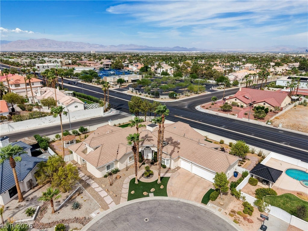2000 Alexa Breanne Court, Las Vegas, NV 89117 An aerial perspective showcases the sweeping tiled roofline and circular driveway of this desert estate.