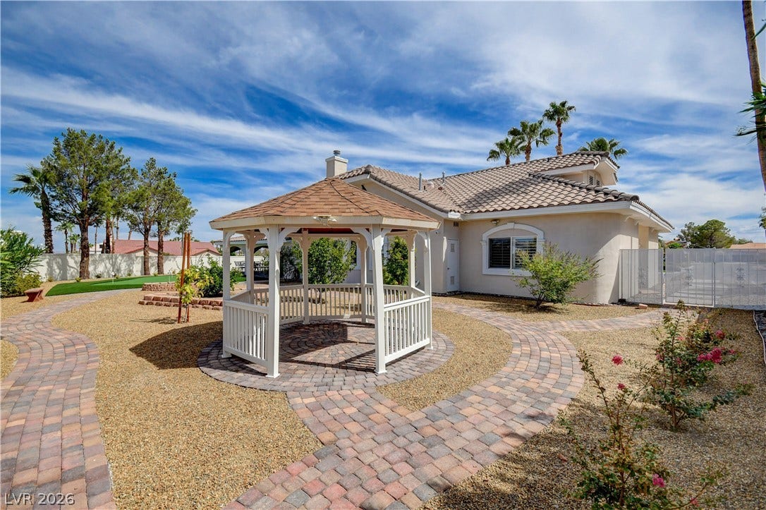 2000 Alexa Breanne Court, Las Vegas, NV 89117 Curving paver walkways wind through the low-maintenance desert landscaping toward a central backyard gazebo.