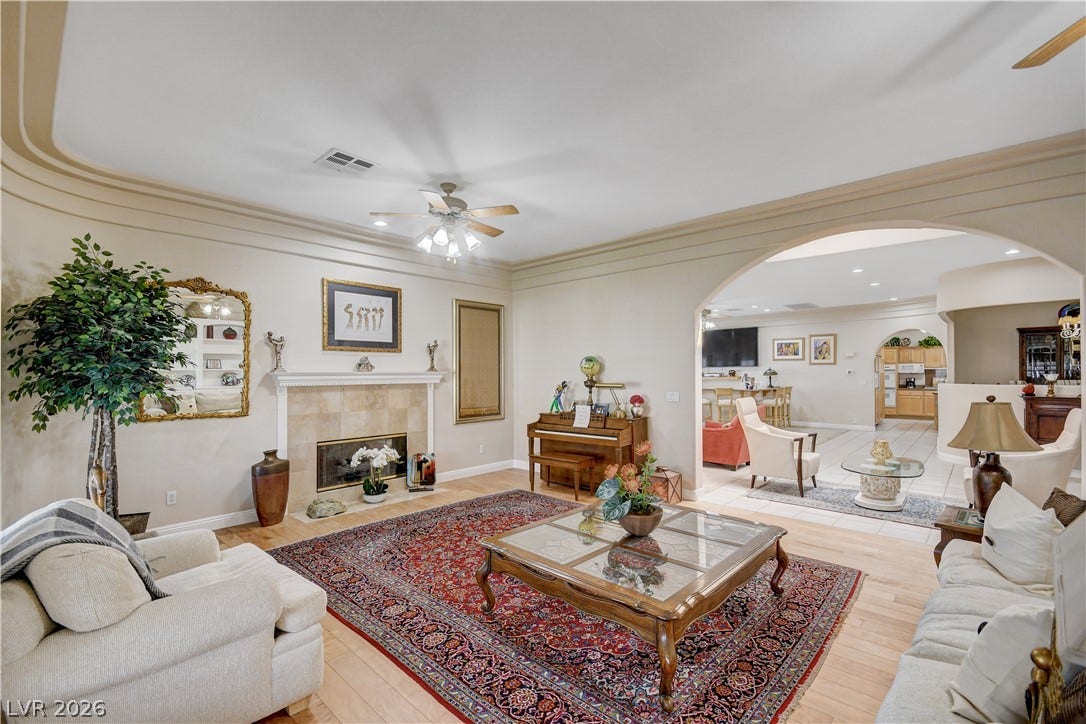 2000 Alexa Breanne Court, Las Vegas, NV 89117 An elegant fireplace with classic molding anchor this spacious, open living area with hardwood floors.