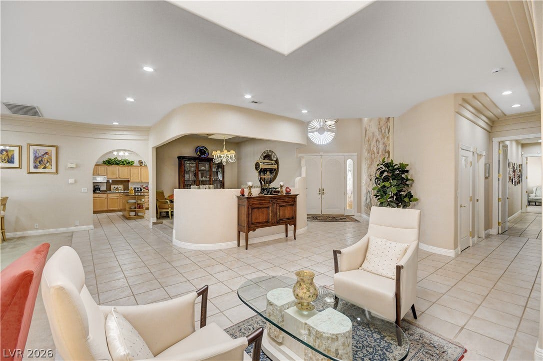 2000 Alexa Breanne Court, Las Vegas, NV 89117 Tiled flooring and a skylight anchor this open, curved-wall living area.