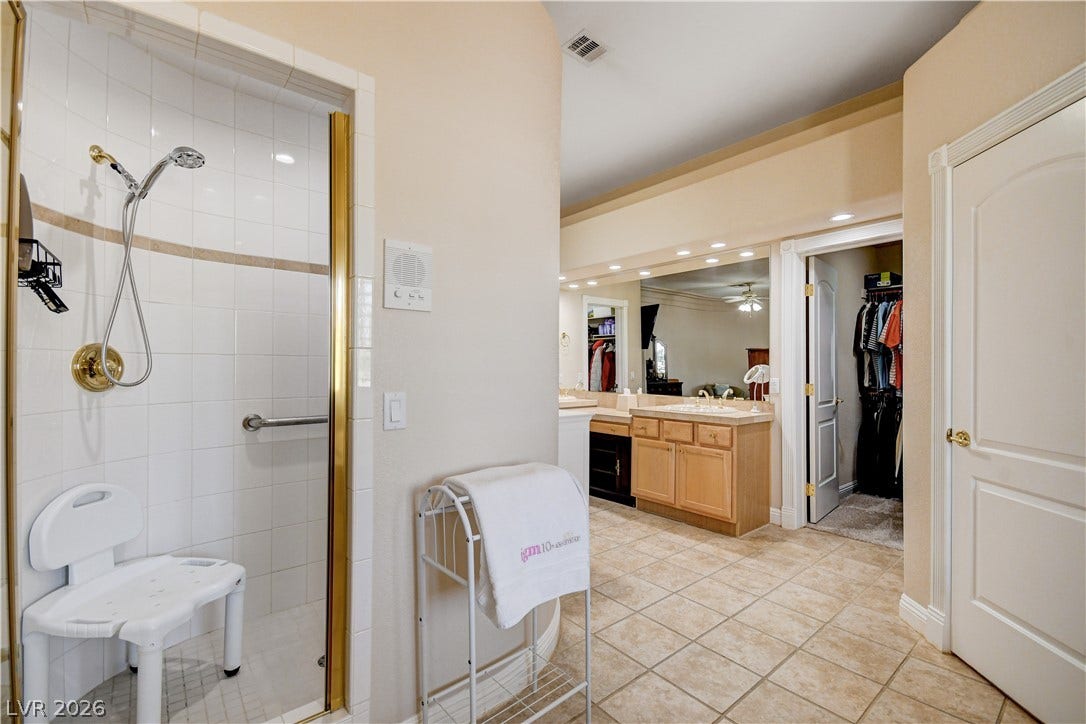 2000 Alexa Breanne Court, Las Vegas, NV 89117 A spacious bathroom features a tile-surround walk-in shower and tiled floors.