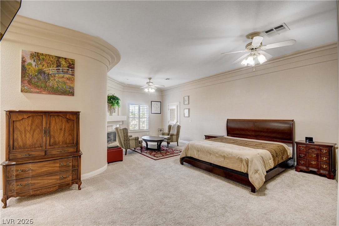 2000 Alexa Breanne Court, Las Vegas, NV 89117 Crown molding and soft carpeting define this spacious bedroom suite.