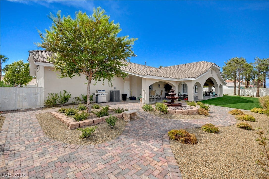 2000 Alexa Breanne Court, Las Vegas, NV 89117 Exquisite brick paver paths wind through a beautifully landscaped backyard featuring a tiered stone fountain.