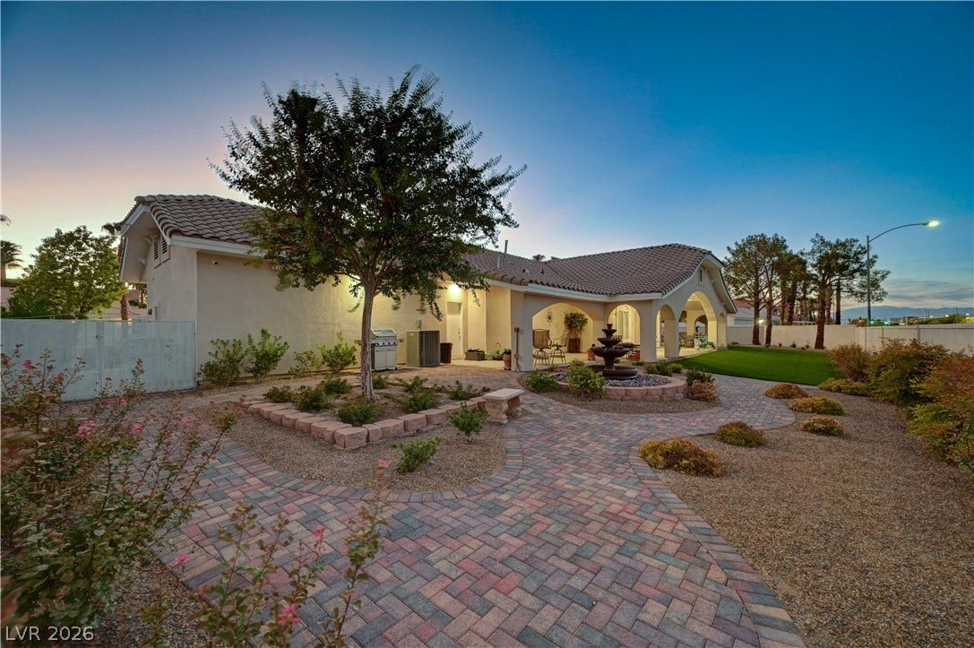 2000 Alexa Breanne Court, Las Vegas, NV 89117 An inviting tiled patio and manicured pathways wind through the spacious backyard of this residence.