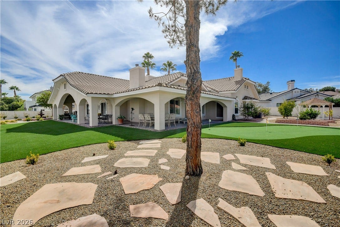 2000 Alexa Breanne Court, Las Vegas, NV 89117 Arched covered patios extend along the back of this stucco home bordering manicured lawns.