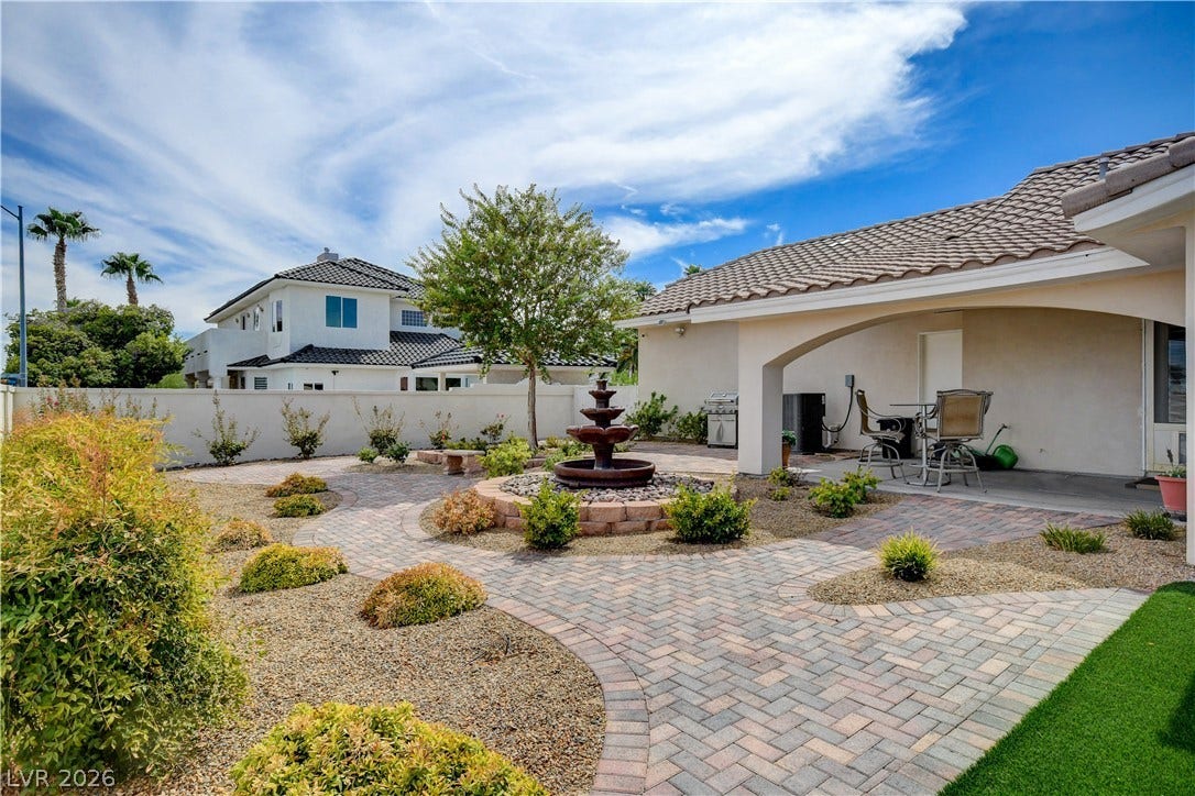 2000 Alexa Breanne Court, Las Vegas, NV 89117 Artfully designed paver pathways wind through low-maintenance landscaping surrounding a central stone fountain.