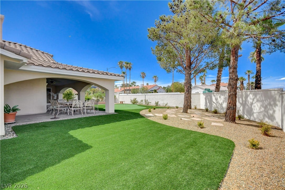 2000 Alexa Breanne Court, Las Vegas, NV 89117 Mature trees shade a low-maintenance gravel and turf yard bordered by privacy walls.