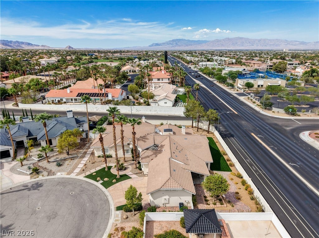 2000 Alexa Breanne Court, Las Vegas, NV 89117 Distant mountains frame this prominent corner property nestled alongside a palm-lined neighborhood thoroughfare.