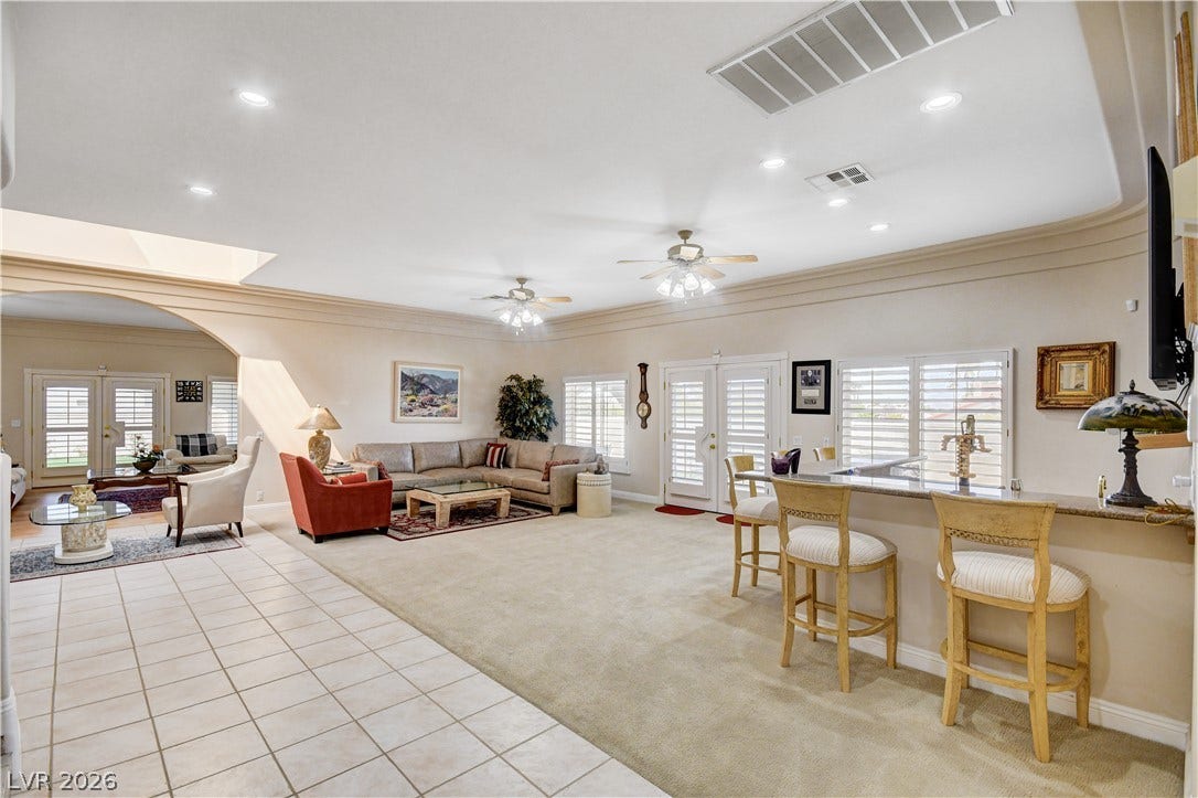 2000 Alexa Breanne Court, Las Vegas, NV 89117 An open floorplan seamlessly connects the tiled entry to a carpeted living space with crown molding.