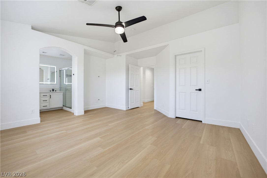4722 Casa Bonita Drive, North Las Vegas, NV 89032 Gleaming hardwood floors and a vaulted ceiling elevate this airy, light-filled primary suite.