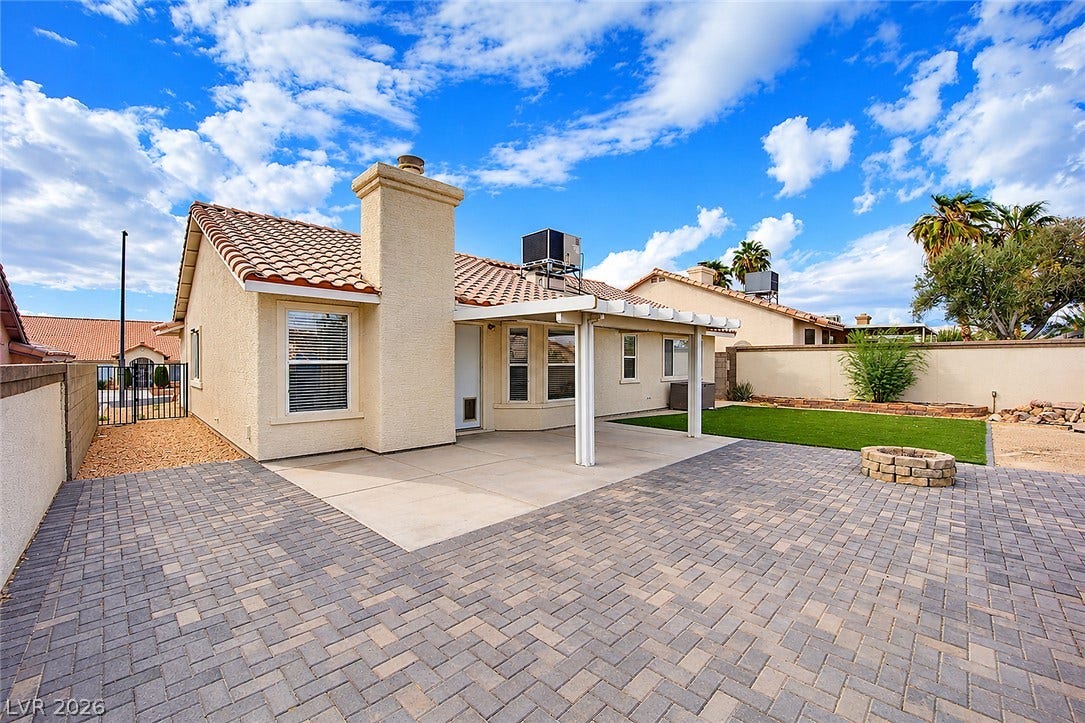 4722 Casa Bonita Drive, North Las Vegas, NV 89032 An inviting backyard patio paved with stone blocks extends to a manicured lawn.