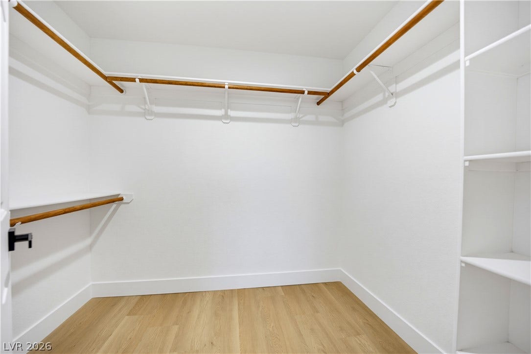 4722 Casa Bonita Drive, North Las Vegas, NV 89032 Ample hanging rods and built-in shelving maximize storage in this wood-floored closet.