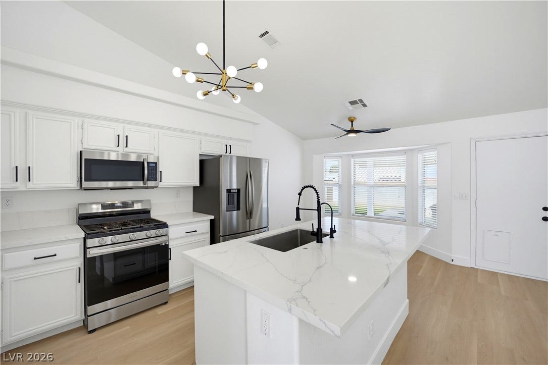4722 Casa Bonita Drive, North Las Vegas, NV 89032 Gleaming stone countertops and stainless steel appliances anchor this light-filled culinary space.