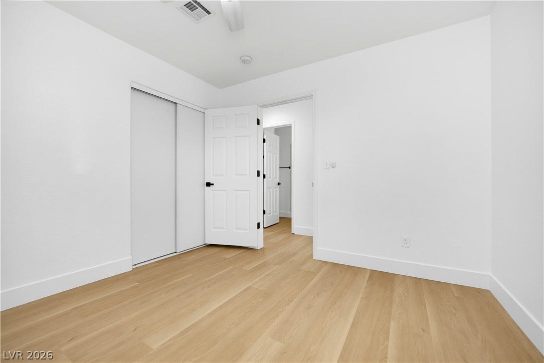 4722 Casa Bonita Drive, North Las Vegas, NV 89032 Smooth wood flooring and clean white walls create a minimalist foundation for this versatile room.