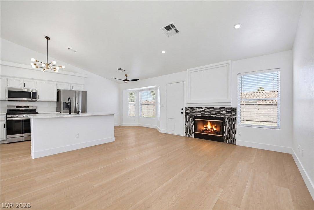 4722 Casa Bonita Drive, North Las Vegas, NV 89032 Crisp white interiors pair with warm wood floors and a modern tile fireplace.