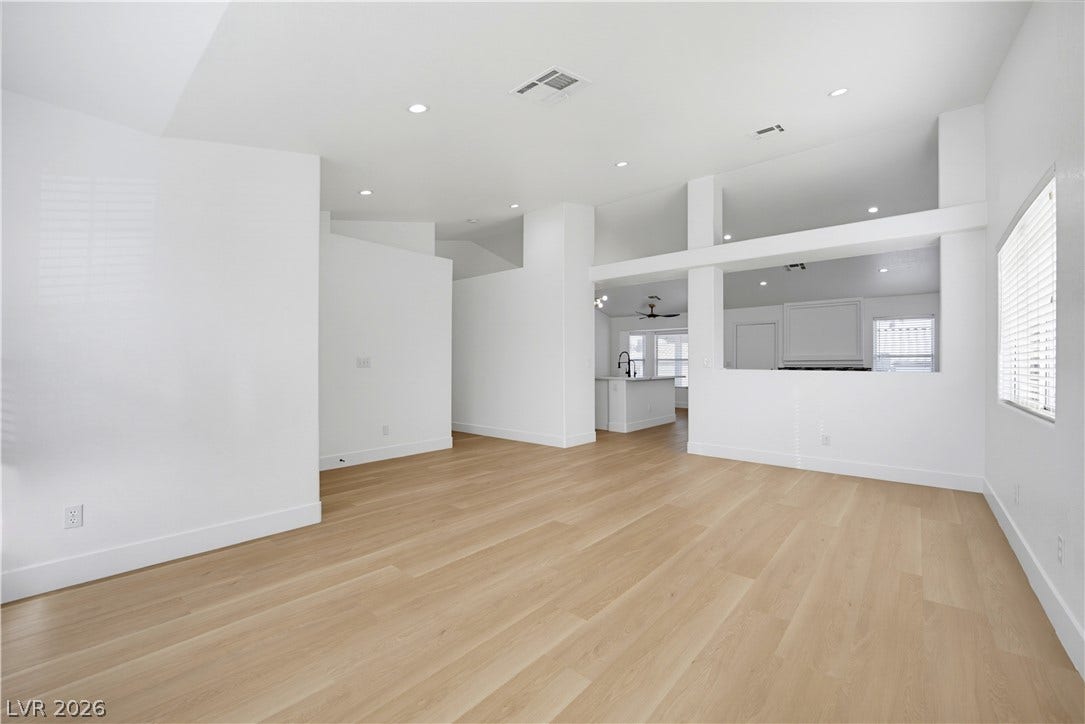 4722 Casa Bonita Drive, North Las Vegas, NV 89032 High ceilings and clean plank flooring define this airy, open-concept interior space.