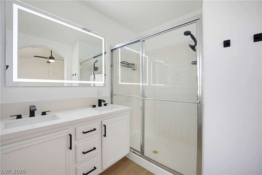 4722 Casa Bonita Drive, North Las Vegas, NV 89032 Clean lines and a double vanity define this modern bathroom with a glass shower enclosure.