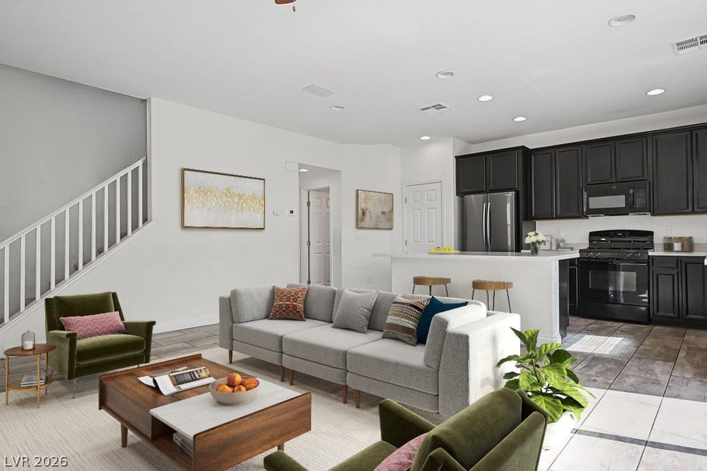 Virtually Staged An open floorplan seamlessly connects the living space and kitchen with modern tile flooring.