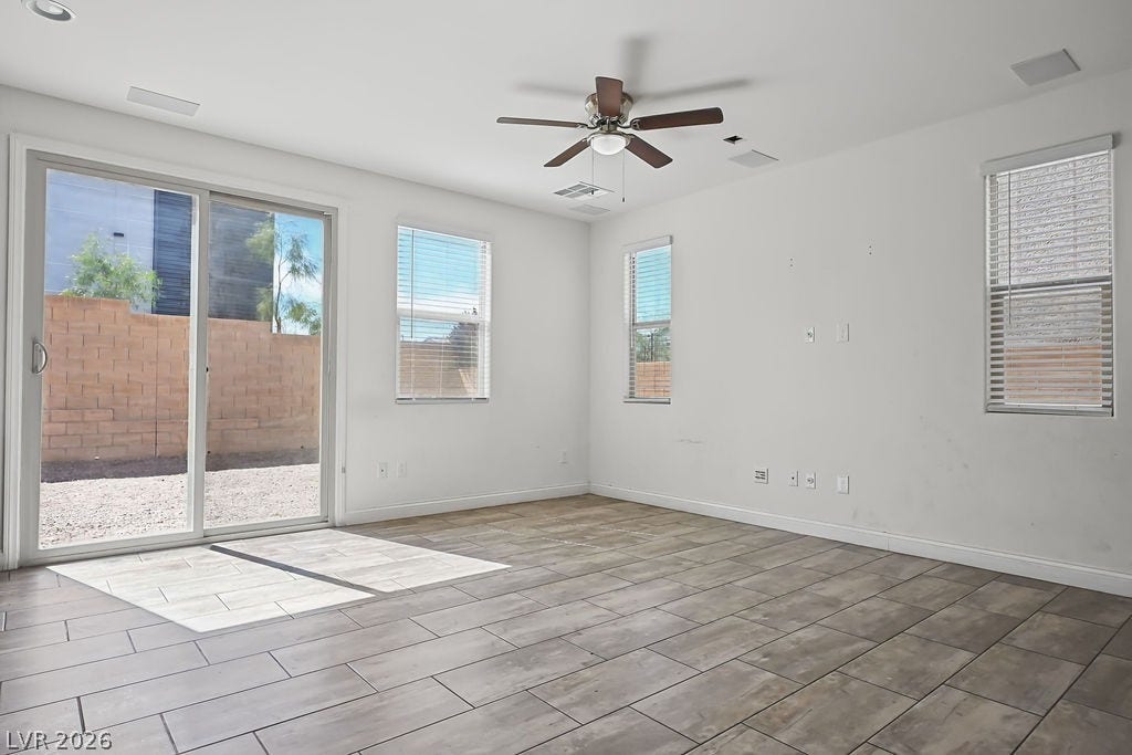 Wood-look tile flooring and clean lines define this versatile open living space.
