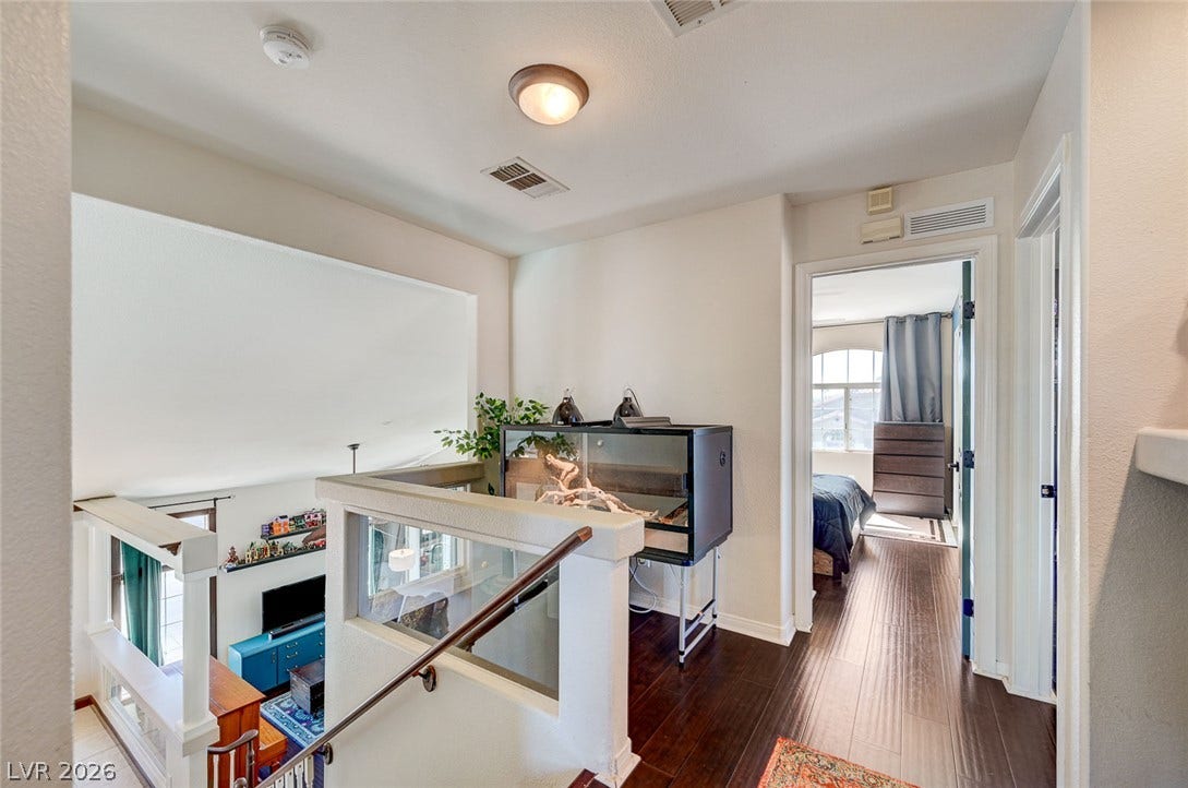 2722 Aspen Wood Avenue, Henderson, NV 89074 Gleaming hardwood floors and a half-wall overlook define this welcoming upper level landing.