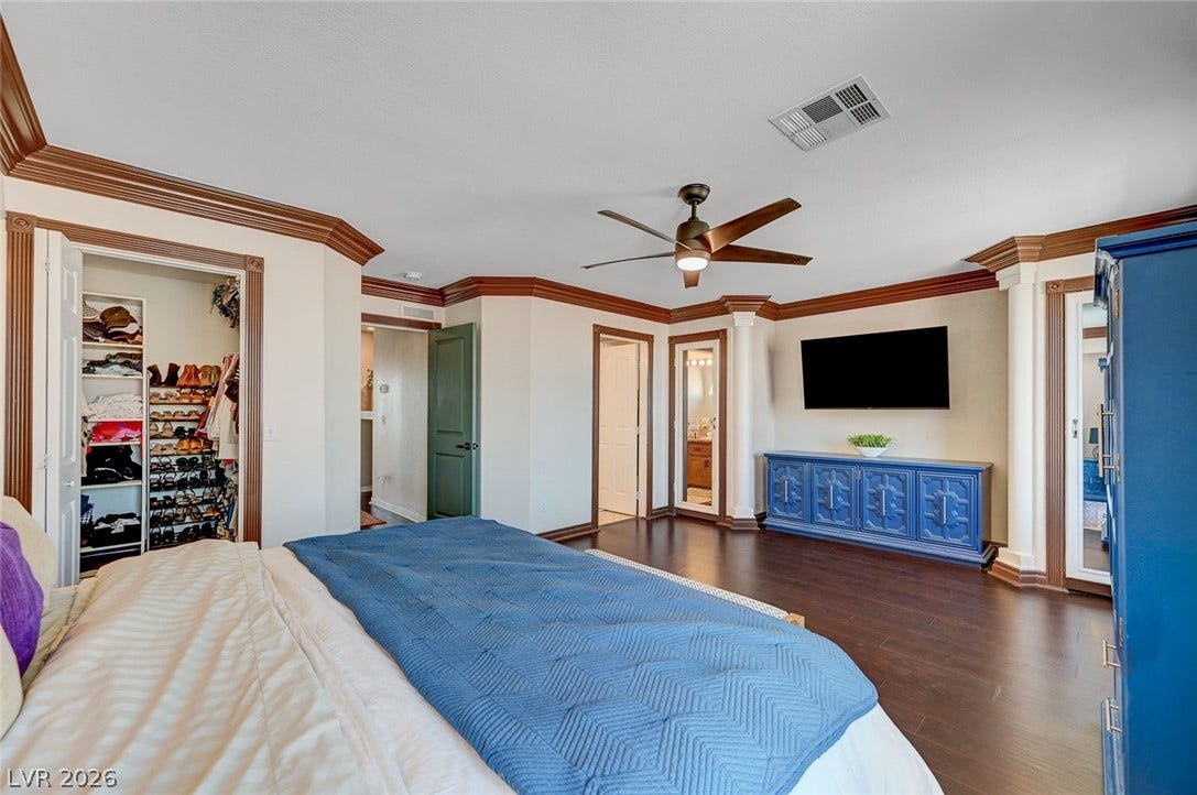 2722 Aspen Wood Avenue, Henderson, NV 89074 Classic crown molding and rich wood flooring define this elegant bedroom suite.