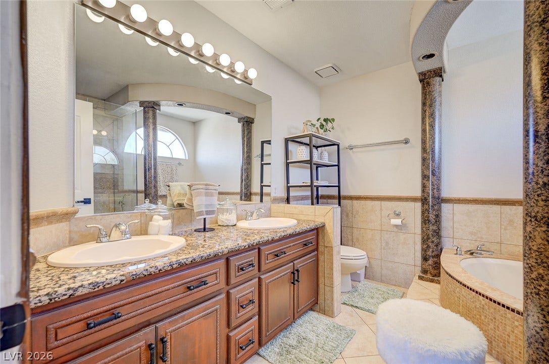 2722 Aspen Wood Avenue, Henderson, NV 89074 Granite counters and textured columns frame this classic master bath with a deep soaking tub.