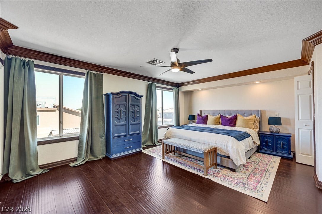 2722 Aspen Wood Avenue, Henderson, NV 89074 Gleaming hardwood floors and classic crown molding define this well-proportioned bedroom suite.