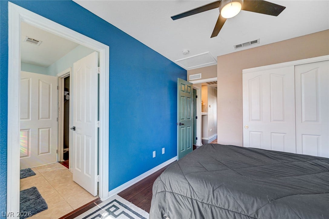 2722 Aspen Wood Avenue, Henderson, NV 89074 Gleaming hardwood floors and a sliding closet door anchor this comfortable bedroom space.