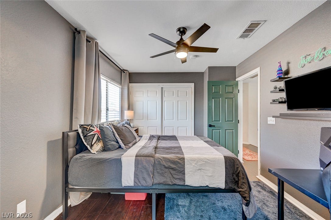 2722 Aspen Wood Avenue, Henderson, NV 89074 Rich hardwood flooring anchors this comfortable bedroom complete with a built-in closet.
