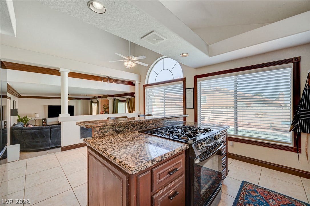 2722 Aspen Wood Avenue, Henderson, NV 89074 Polished granite countertops and classic tile flooring enhance this open kitchen layout.