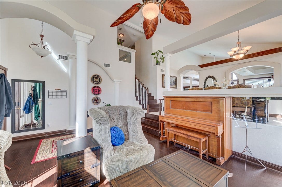 2722 Aspen Wood Avenue, Henderson, NV 89074 Rich hardwood flooring complements soaring ceilings and architectural columns in this open living space.