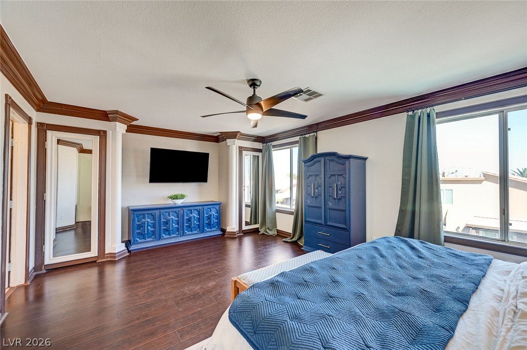 2722 Aspen Wood Avenue, Henderson, NV 89074 Classic crown molding and rich wood flooring define this comfortable main floor bedroom suite.