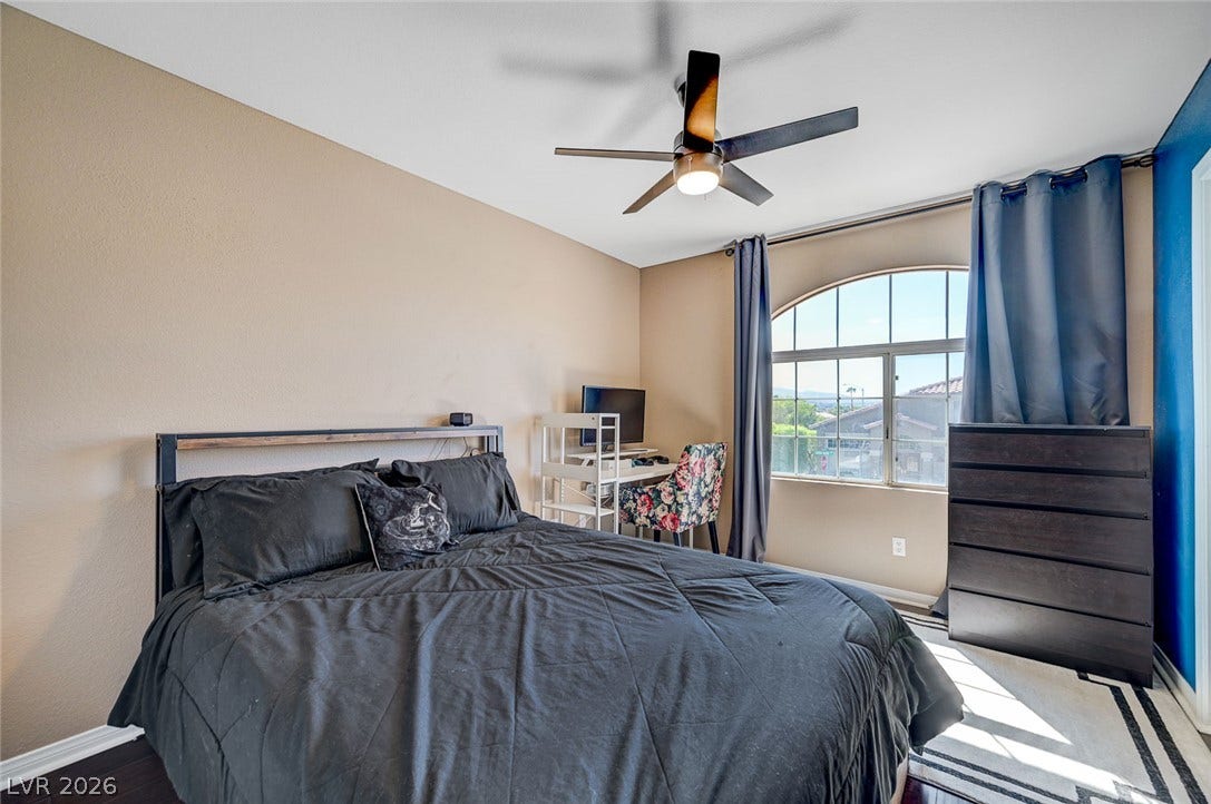 2722 Aspen Wood Avenue, Henderson, NV 89074 An arched window frames neighborhood views, bringing abundant light across the hardwood flooring.