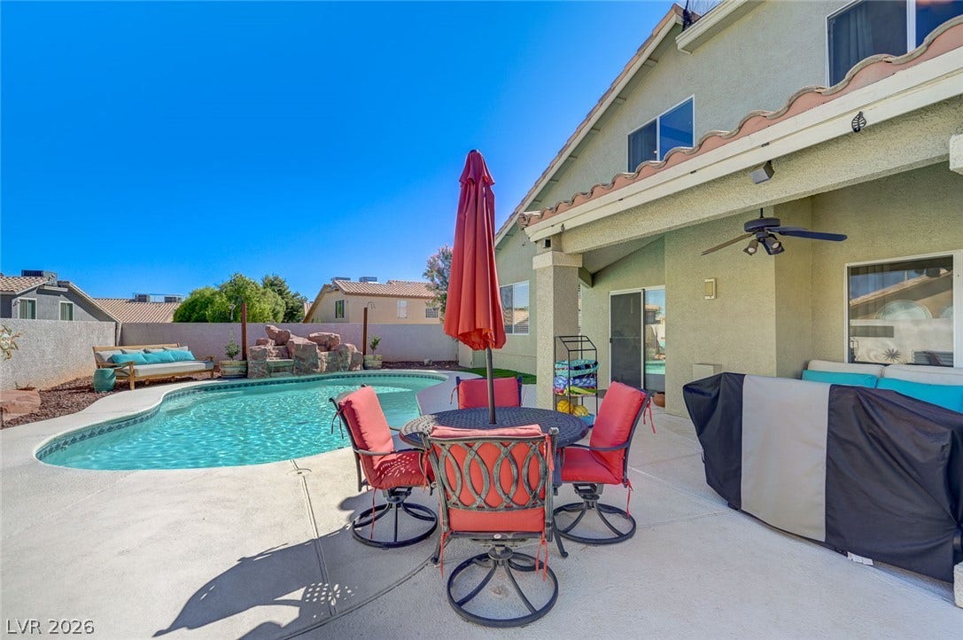 2722 Aspen Wood Avenue, Henderson, NV 89074 An inviting backyard oasis features a sparkling in-ground pool surrounded by spacious concrete decking.