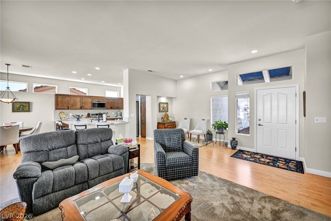10020 Villa Ridge Drive, Las Vegas, NV 89134 Gleaming wood floors flow from the bright entryway into a spacious open-concept living area.