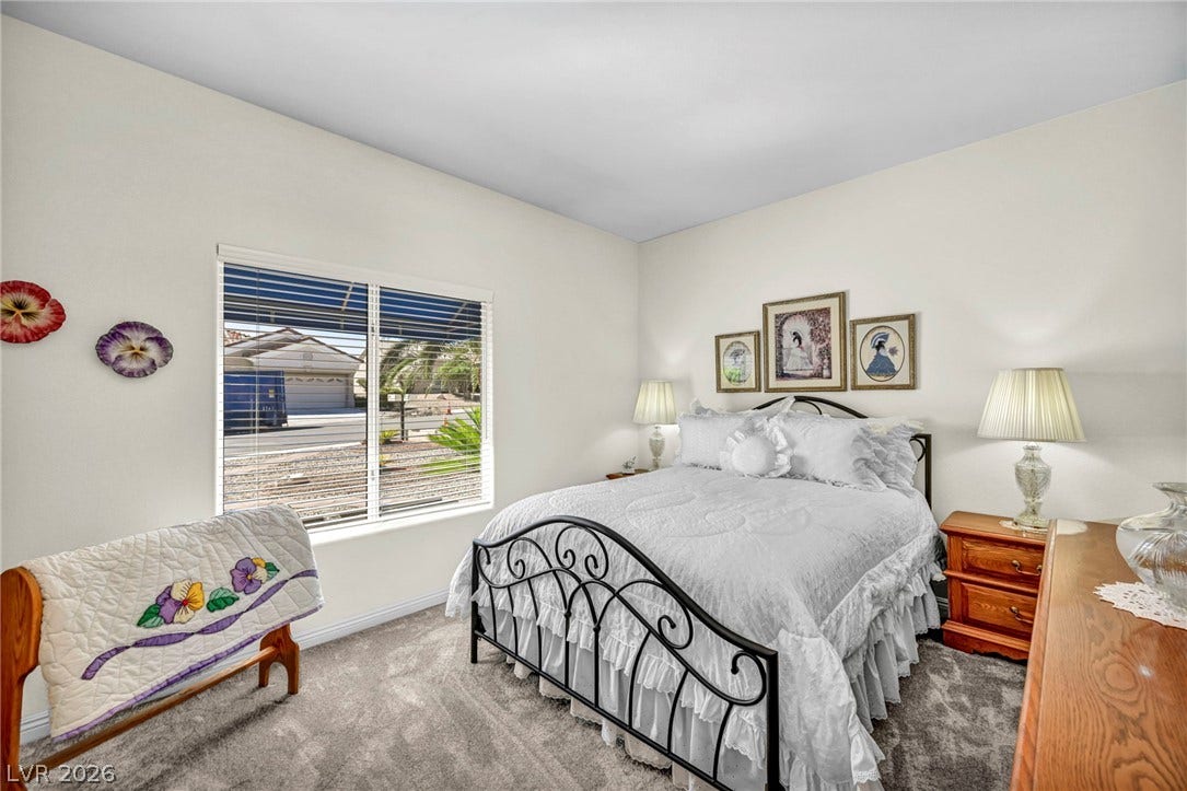 10020 Villa Ridge Drive, Las Vegas, NV 89134 Natural light streams through a wide window, highlighting the soft carpeting and tall ceilings.