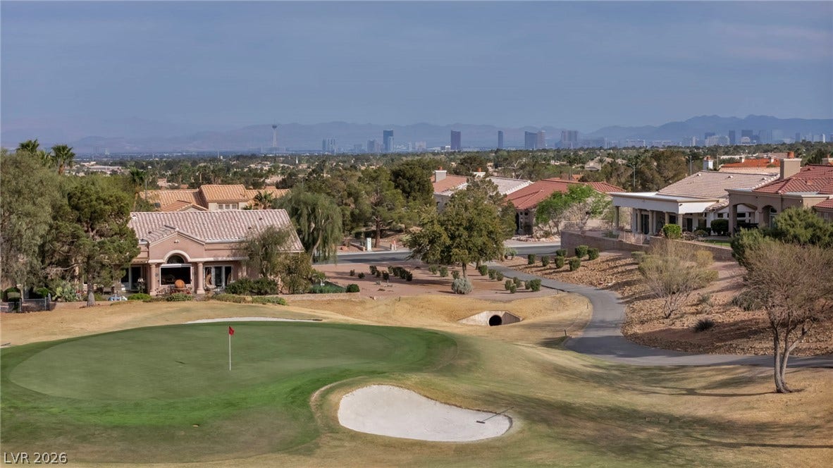 10020 Villa Ridge Drive, Las Vegas, NV 89134 Golf course living merges with distant city skyline and mountain views under wide desert skies.