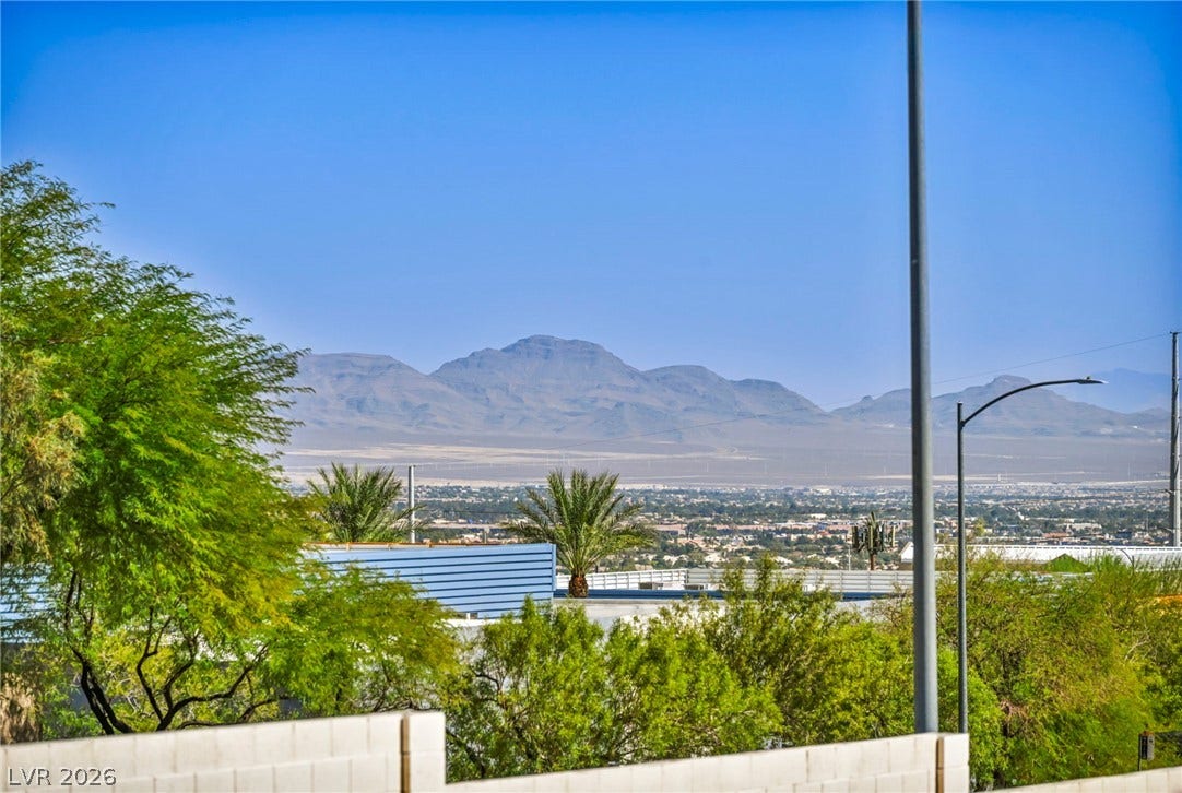 10020 Villa Ridge Drive, Las Vegas, NV 89134 Rugged mountains frame the distant horizon beyond the neighborhood treetops.