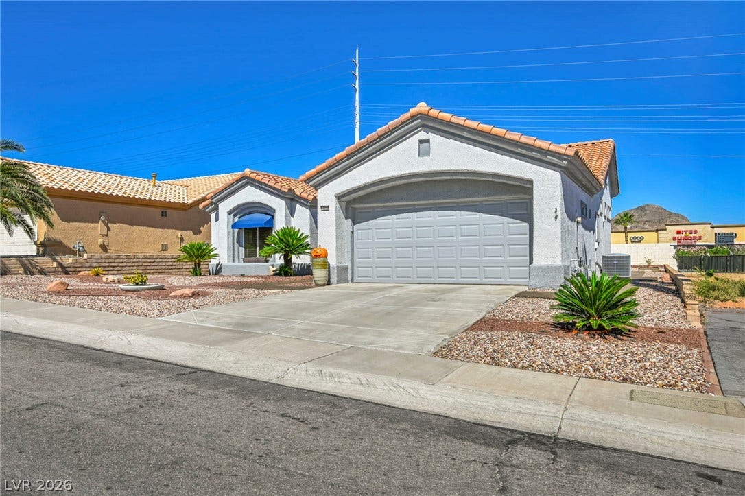 10020 Villa Ridge Drive, Las Vegas, NV 89134 A classic stucco exterior pairs with a durable tile roof and low-maintenance desert landscaping.