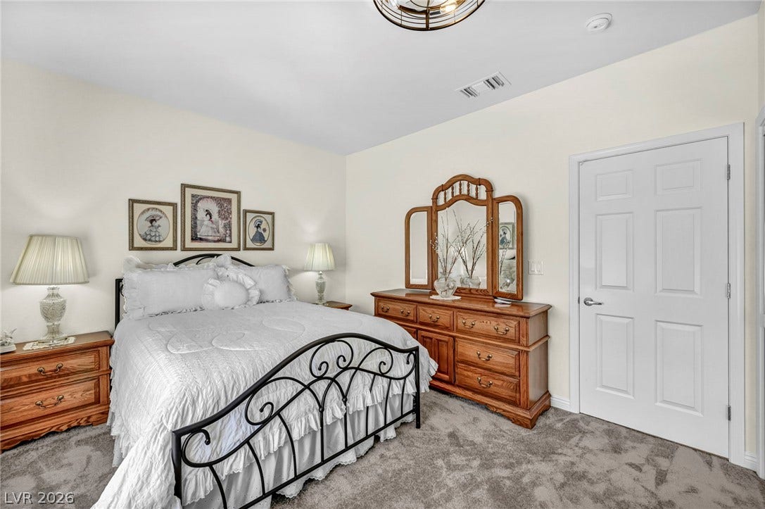 10020 Villa Ridge Drive, Las Vegas, NV 89134 Plush carpeting anchors this comfortable bedroom complete with classic paneled doors and smooth plasterwork.