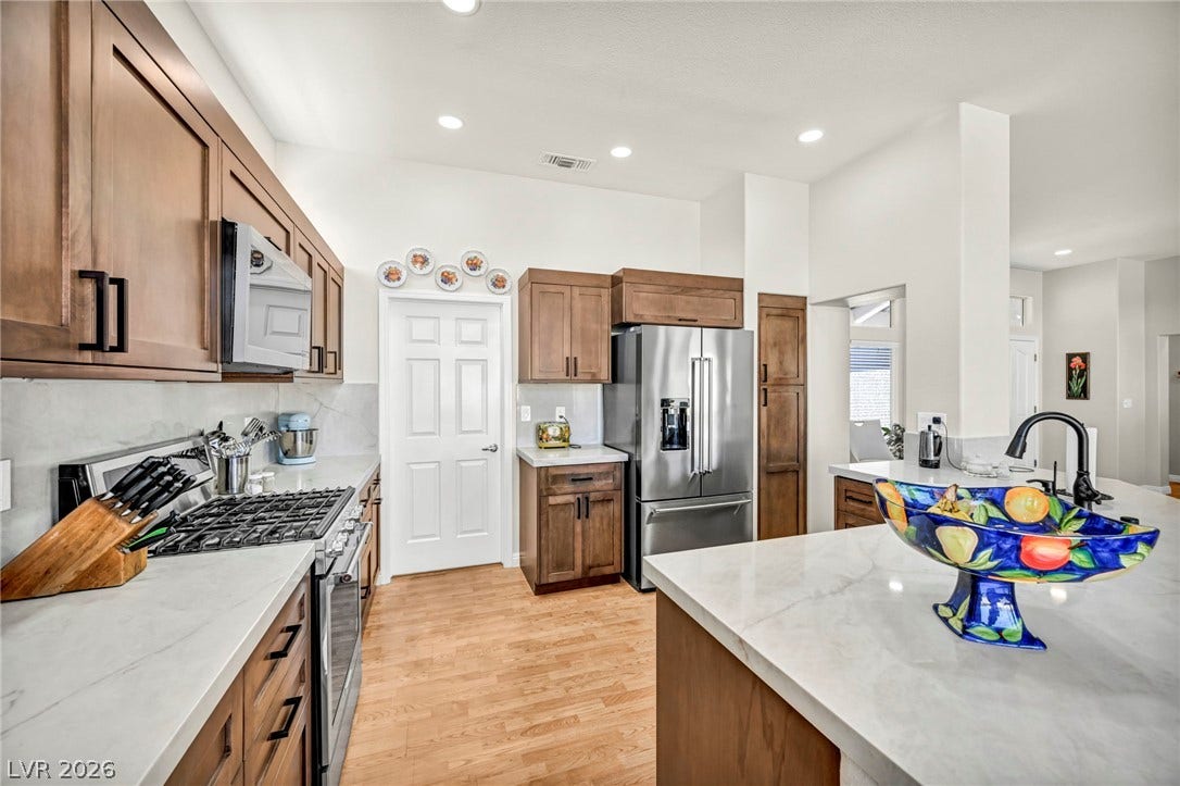 10020 Villa Ridge Drive, Las Vegas, NV 89134 Gleaming stone countertops and warm wood flooring define this updated culinary space.